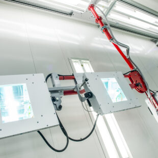 Blowtherm-UV dryers for curing spray paint. Motorized overhead rail installation.